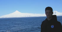 Captain Hoshlyk of the Oscar Dyson with Mt. Shishaldin in the background