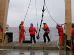 Photo:  using a grappling hook to find a fallen mooring.