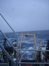 alt="A vew of the fantail of the Oscar Dyson showing A-frame and 2 cranes"