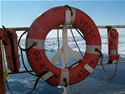 image: Life buoy on USCGC Healy with 
			  icy sea background. Photo by C.Ladd